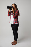 Studio Portrait Of Female Photographer With Camera