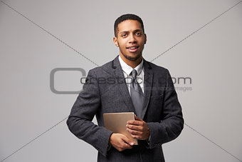 Studio Portrait Of Businessman Using Digital Tablet