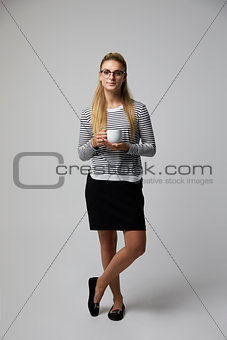 Studio Portrait Of Young Businesswoman Drinking Coffee