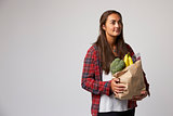 Studio Portrait Of Female Nutritionist With Bag Of Food