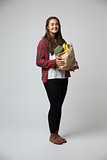 Studio Portrait Of Female Nutritionist With Bag Of Food
