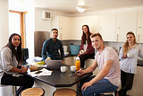 Portrait Of Students Relaxing In Kitchen Of Accommodation