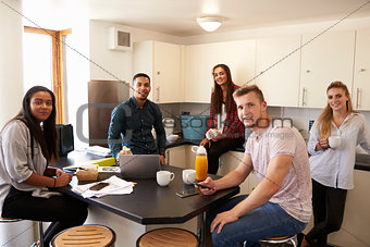 Portrait Of Students Relaxing In Kitchen Of Accommodation