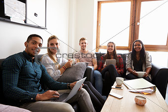 Students Relaxing In Lounge Of Shared Accommodation