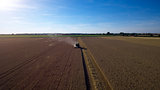 Aerial View Of Combine Harvester Working In Wheat Field