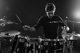 Black And White Shot Of Drummer Playing Drum Kit In Studio