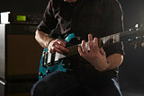 Close Up Of Man Using Tapping Technique On Electric Guitar