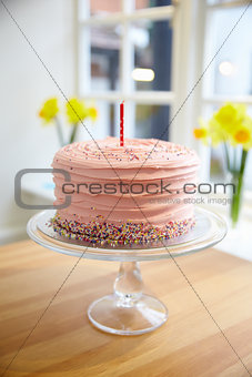 Cake Celebrating First Birthday On Display In Shop Window