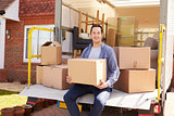 Man Unpacking Moving In Boxes From Removal Truck