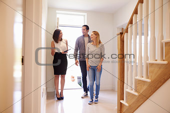 Realtor Showing Young Couple Around Property For Sale