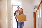 Couple Carrying Boxes Into New Home On Moving Day