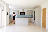 Female Realtor In Kitchen Carrying Out Valuation