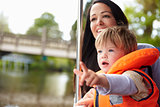 Mother And Son Enjoying Day Out In Boat On River Together