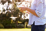 Close Up Of Woman Flying Drone Quadcopter In Garden