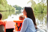 Mother And Sons Enjoying Day Out In Boat On River Together