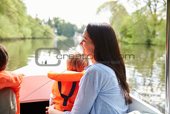 Mother And Sons Enjoying Day Out In Boat On River Together