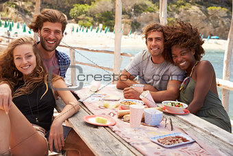 Two couples sitting together at a table by the sea, Ibiza