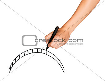 A female hand holds black marker and draws bridge