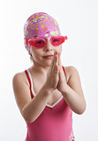 A girl in a swimsuit and a swimming cap