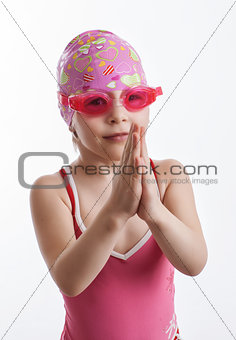 A girl in a swimsuit and a swimming cap