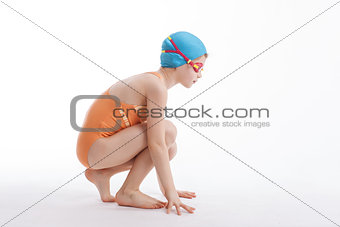 The girl is sitting in a swimming suit