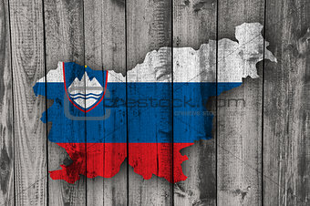 Map and flag of Slovenia on weathered wood