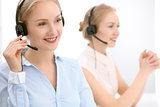 Call center. Focus on beautiful blonde woman in headset