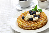 homemade american round waffles with blueberry and banana