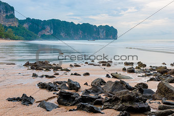 Sharp stones on the sandy beach of the beach in Thailand