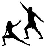 Silhouettes of man and woman practicing yoga