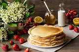 Delicious pancakes on wooden table with fruits