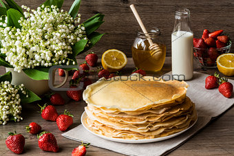 Delicious pancakes on wooden table with fruits