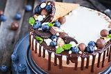 Three chocolate mousse cake decorated with waffle cone, fresh bl