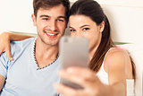 Couple on bed making selfies