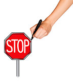 A female hand holds marker and draws stop sign