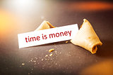 a fortune cookie with message time is money