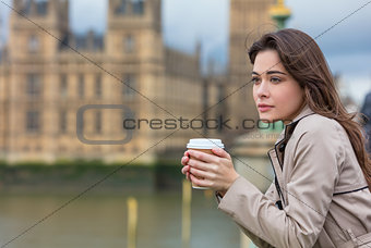 Sad Thoughtful Woman Drinking Coffee in London by Big Ben