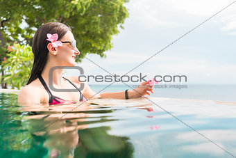 Woman in vacation relaxing swimming in pool
