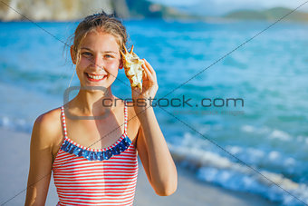 Girl with shell at the beach