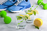 Sport composition with sports equipment glass water with lemon m