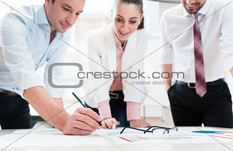 Business people analyzing data - glasses on graph
