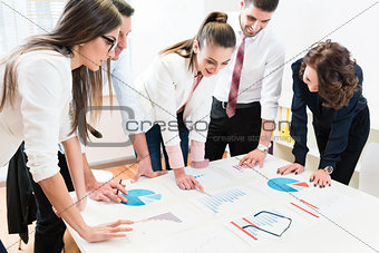 Financial consultants in bank analyzing data