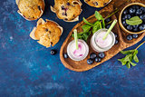Homemade muffins with blueberries and yogurt with mint.