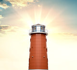A lighthouse against a background of sunrise