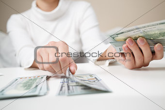 Close up of woman with calculator counting money