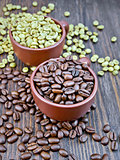Coffee black and green grains in cups on board