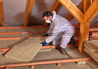 Man laying thermal insulation