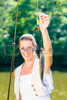 Sport fisherwoman showing her catch