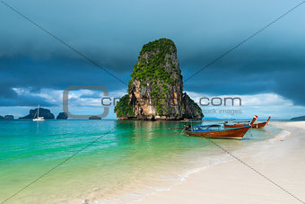 Wooden boats and a high cliff in the sea, Thailand, Phra Nang be