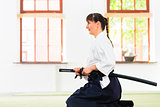 Woman at Aikido martial arts with sword